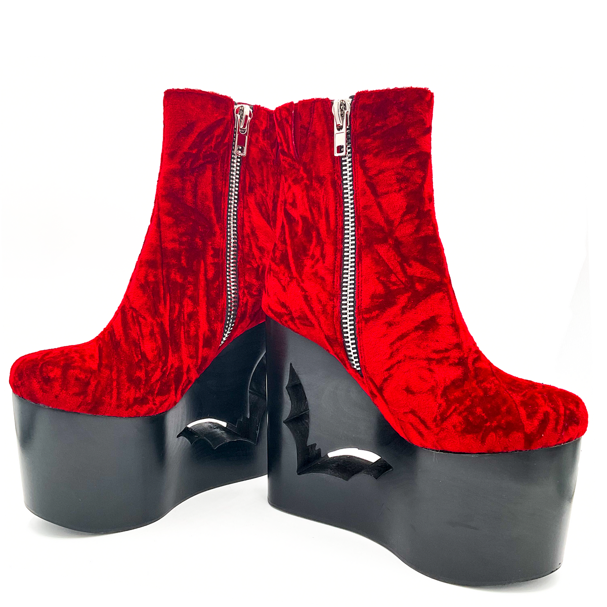 Red platform boots with zippers on a white background